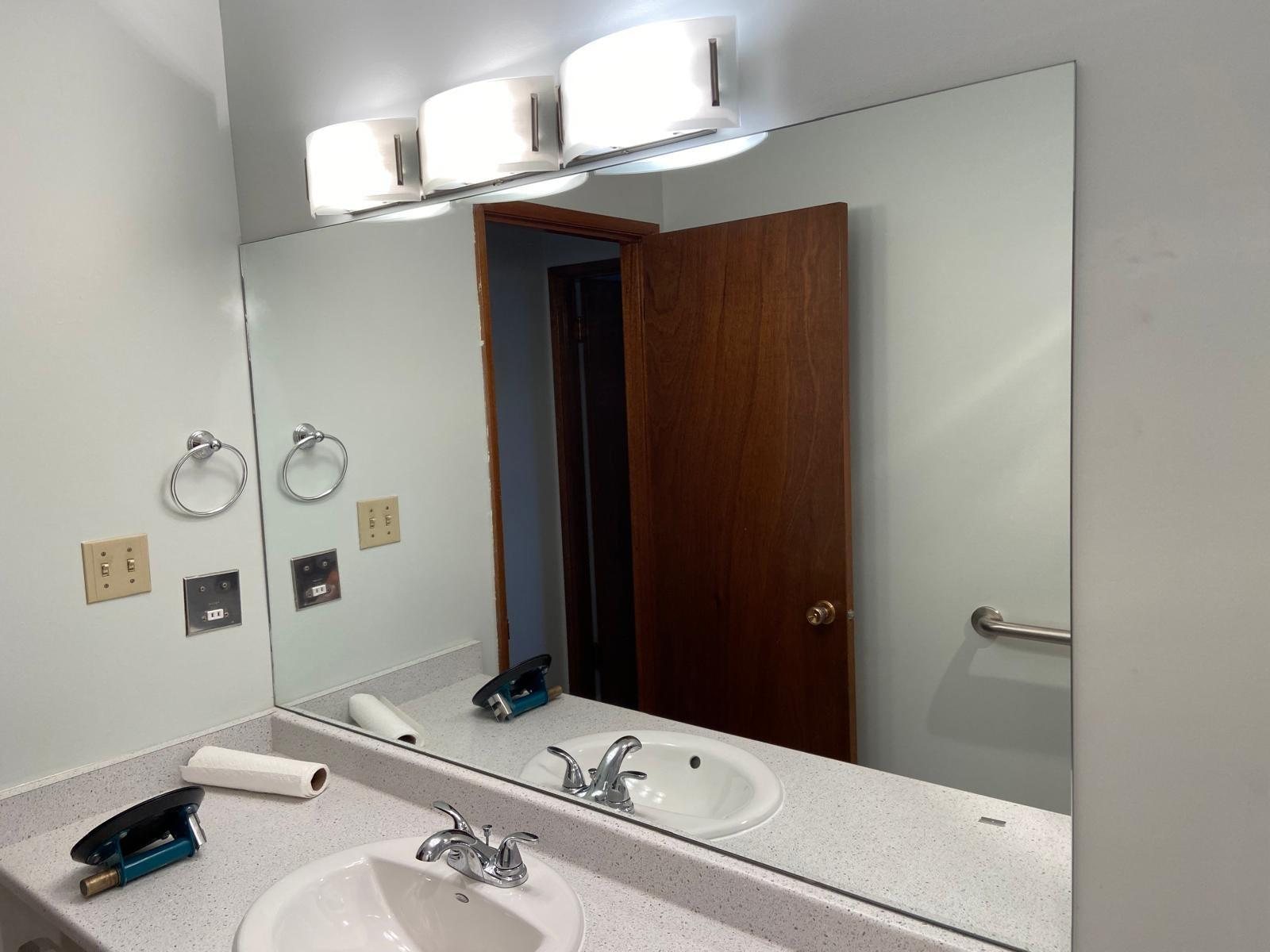 Custom bathroom wall mirror installation