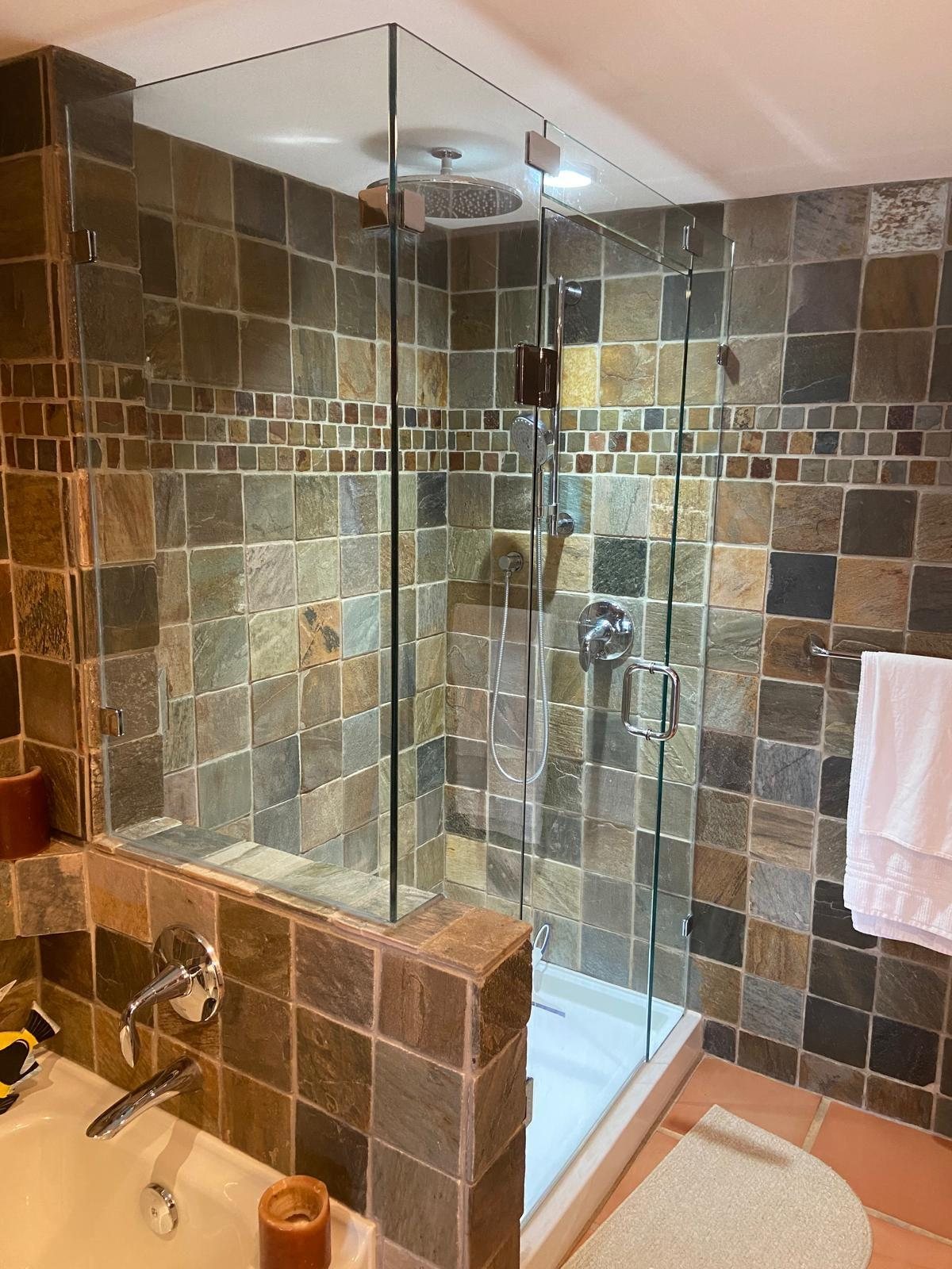 Frameless shower glass enclosure